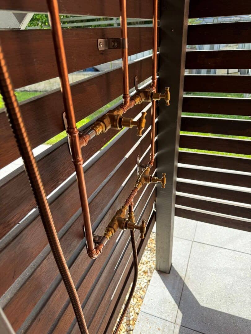 copper pipes on an outdoor wall
