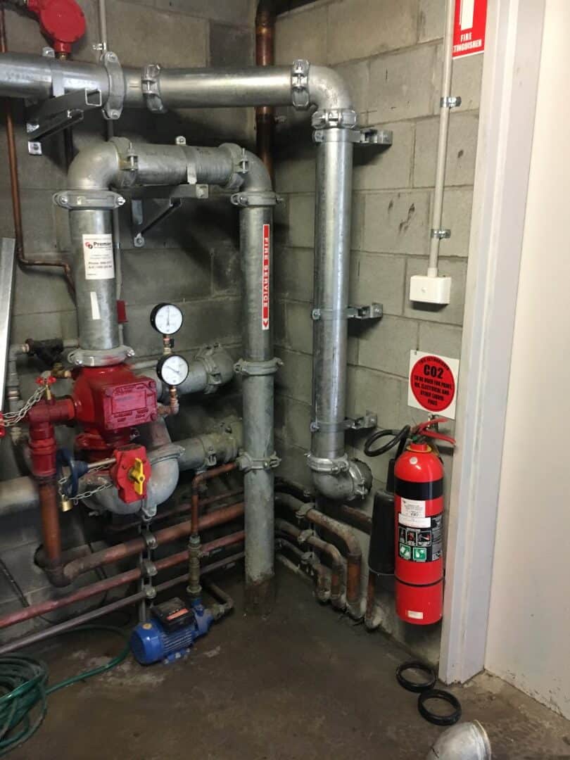 pipes and a fire extinguisher in a room